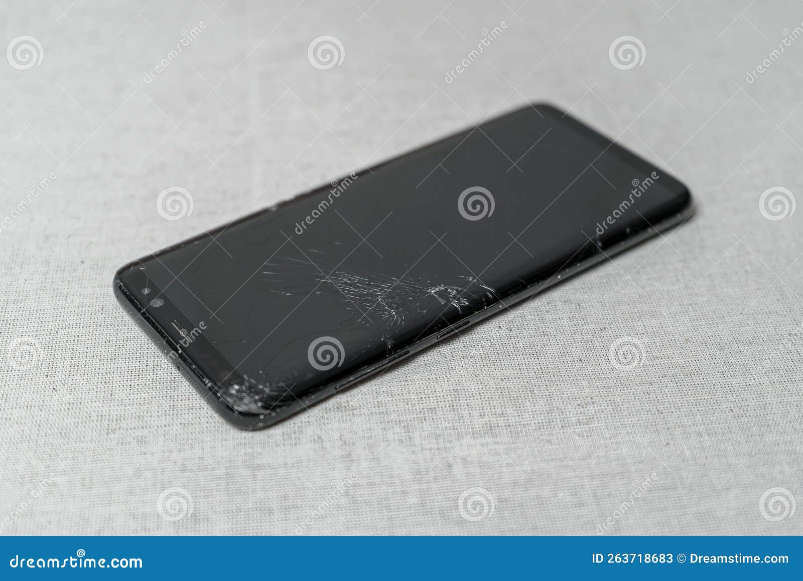 Damaged Mobile Phone with a Cracked Display on the Table Stock Image