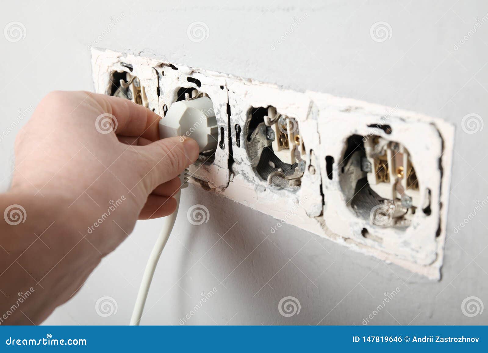 Damaged Power Outlet in the Wall. Electrical Hazard Stock Photo Image