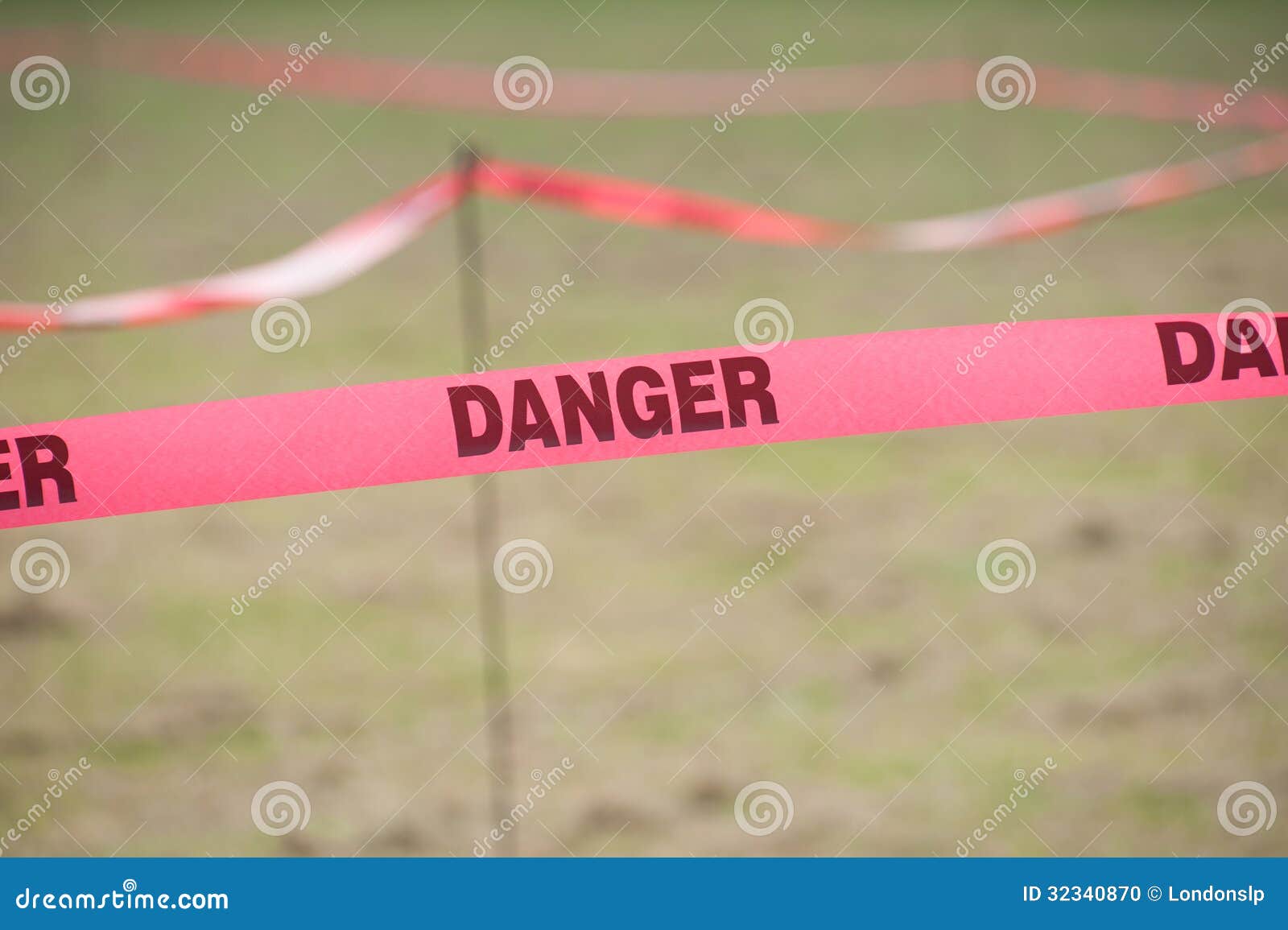 danger boundary tape in a field.