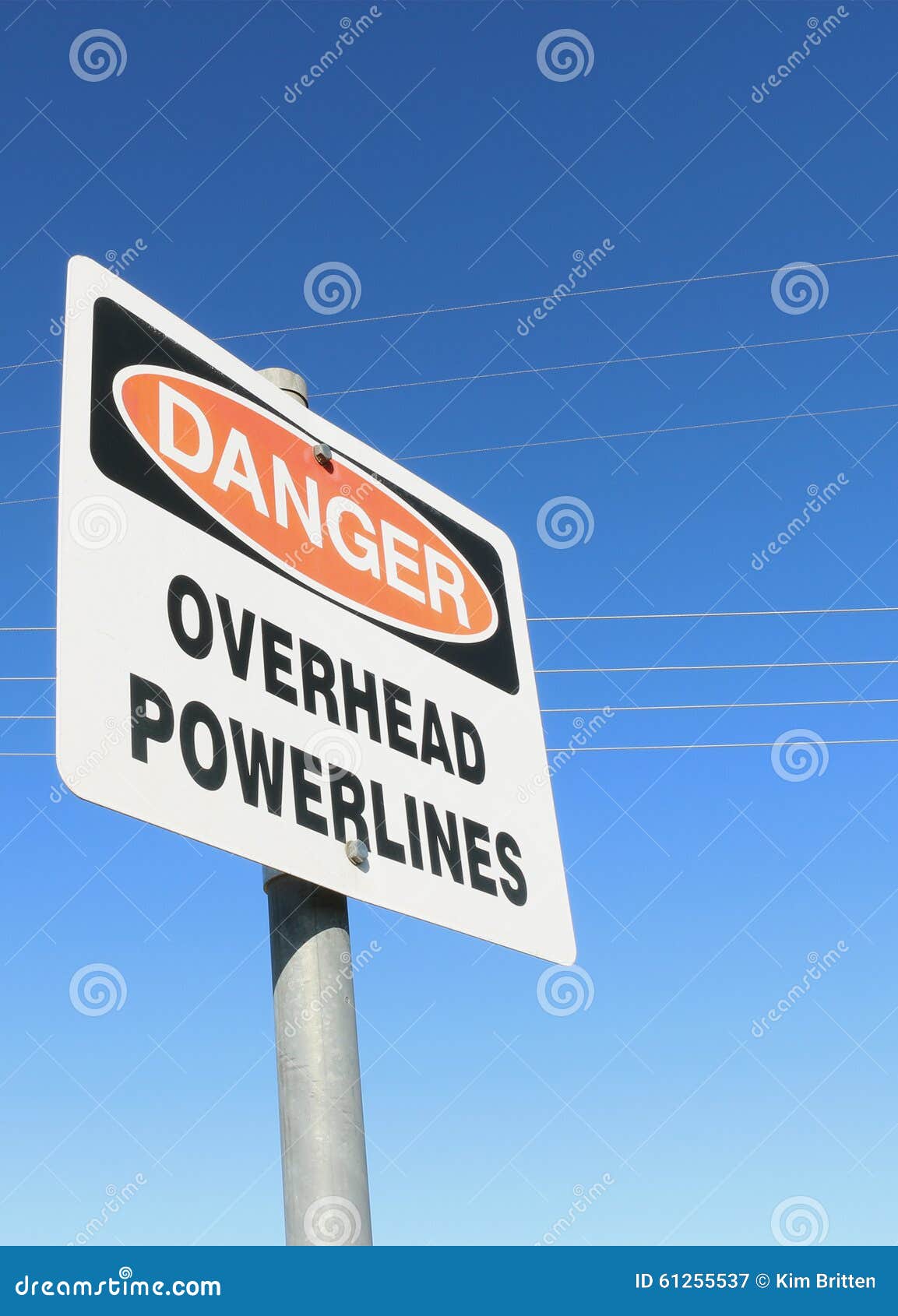 Danger, Overhead Powerlines Warning Sign with Visible Power Lines Stock