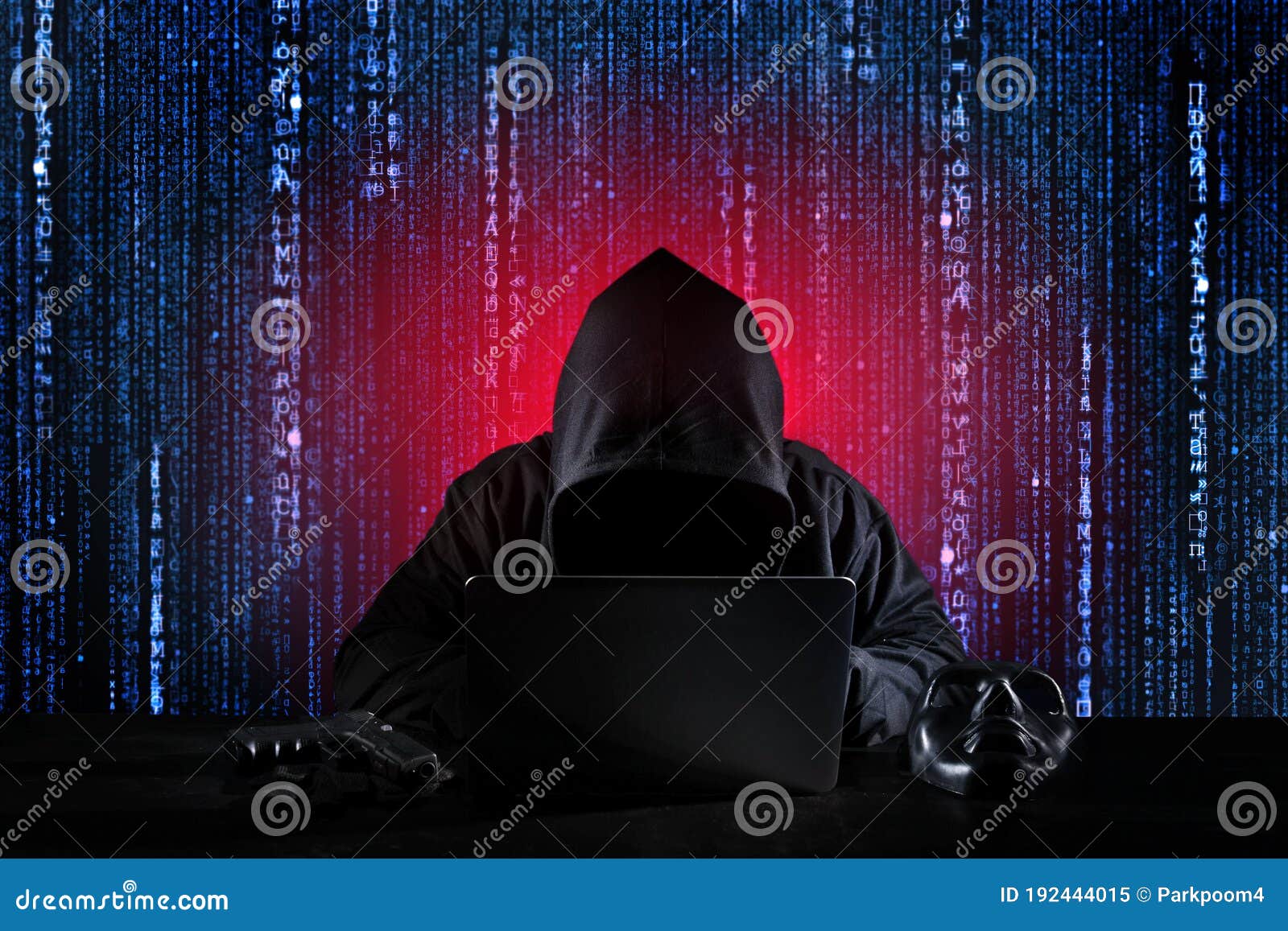 dangerous hacker man in black hooded, masked and gun using computer, breaking into security data and corporate server. he stealing