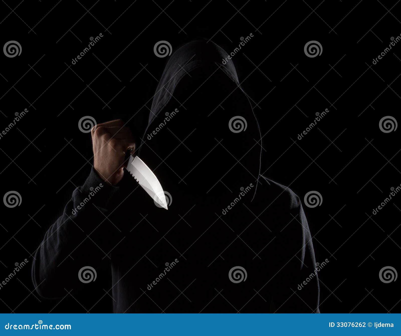 dangerous hooded man holding knife