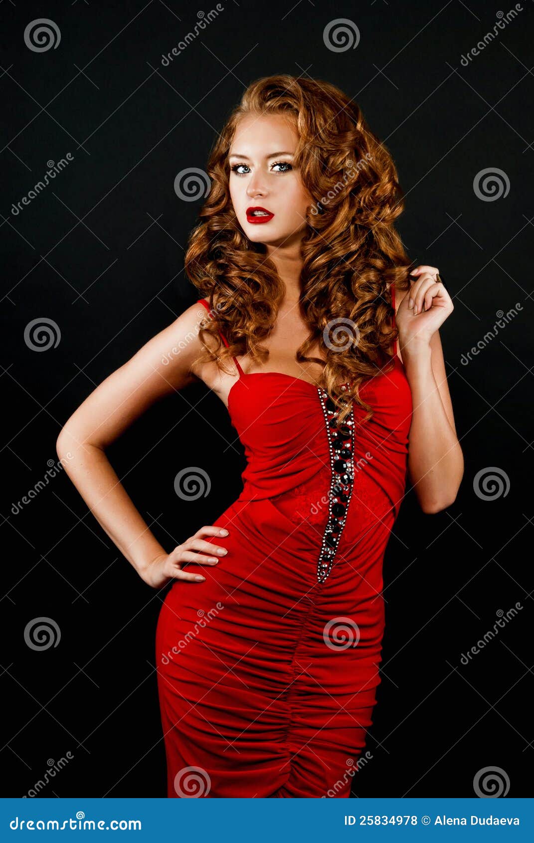 daring red-haired girl in a red dress