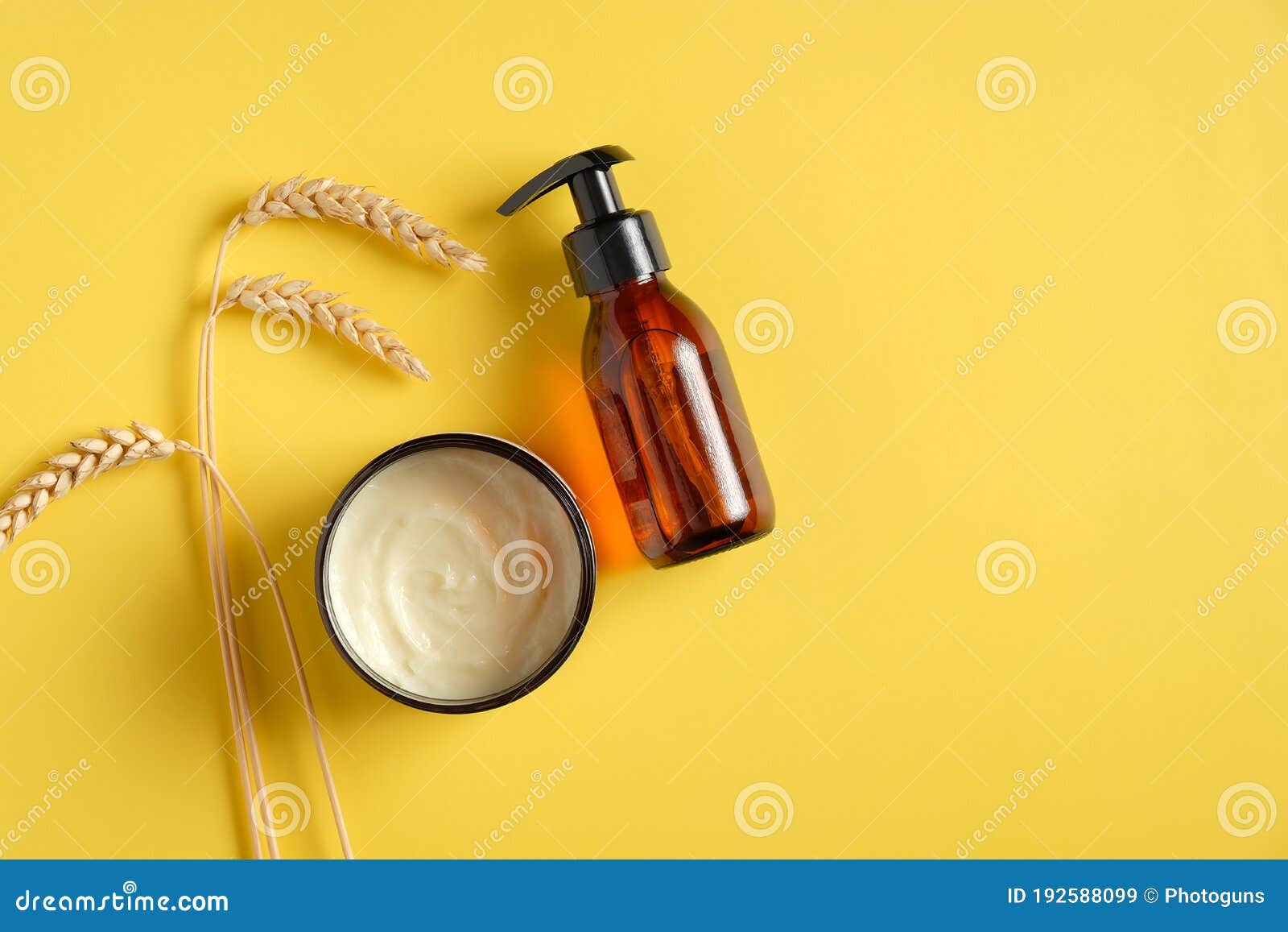 Download Dark Amber Glass Pump Cosmetic Bottle Moisturizer Cream In Jar Wheat On Yellow Background Spa Natural Organic Beauty Products Stock Image Image Of Natural Lotion 192588099