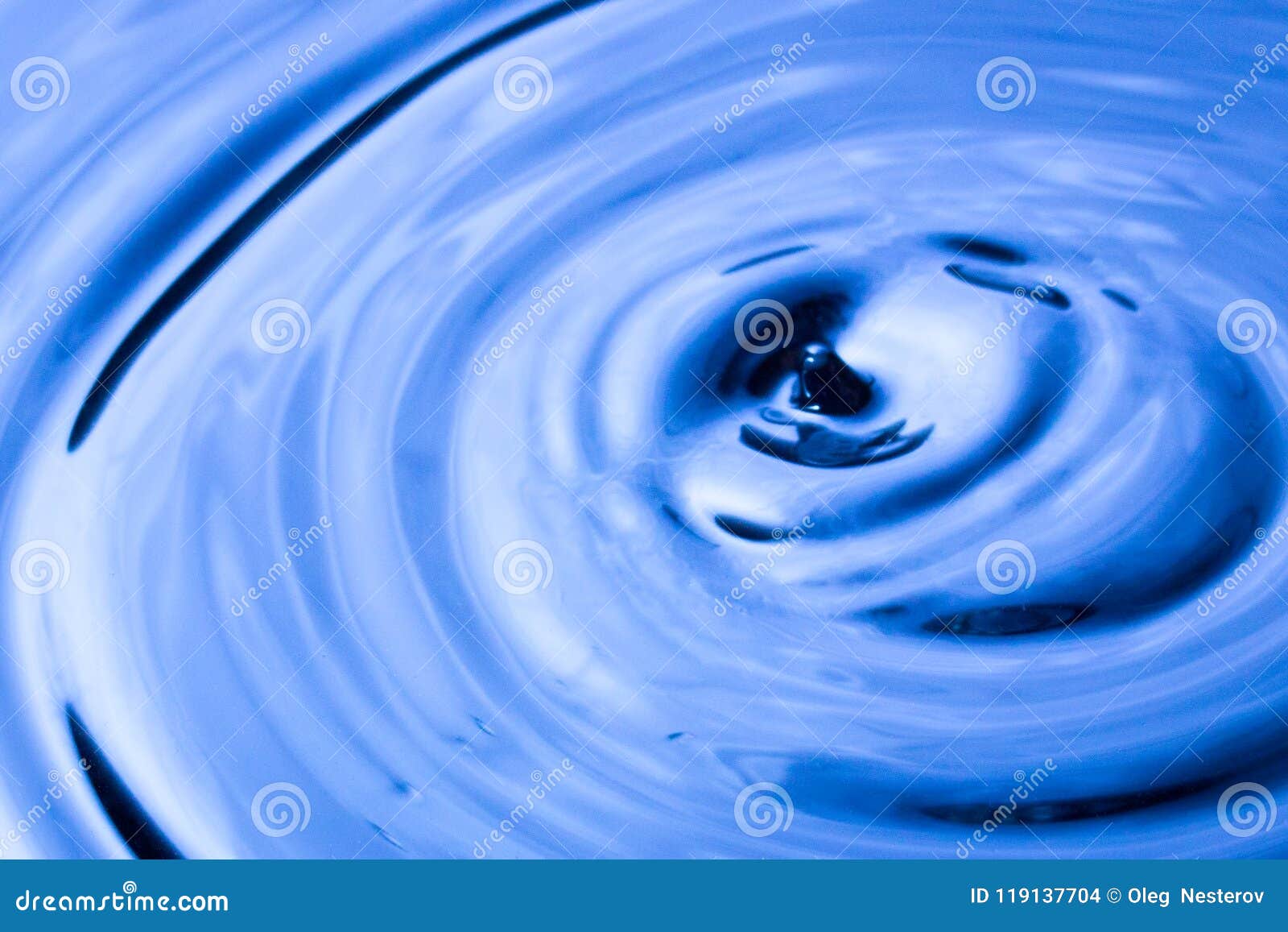 Dark Blue Water and a Drop on the Surface Closeup Stock Photo Image