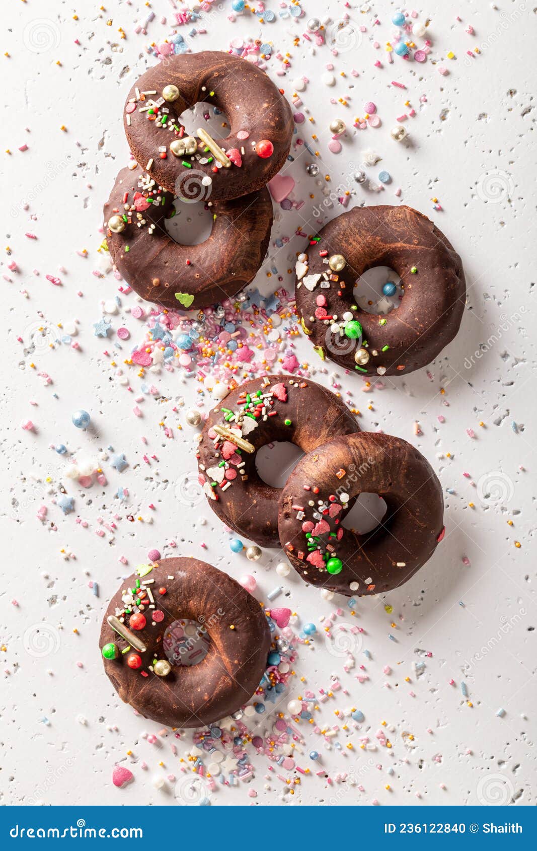 Dark Brownie Donuts with Sprinkles and Chocolate Topping Stock Photo