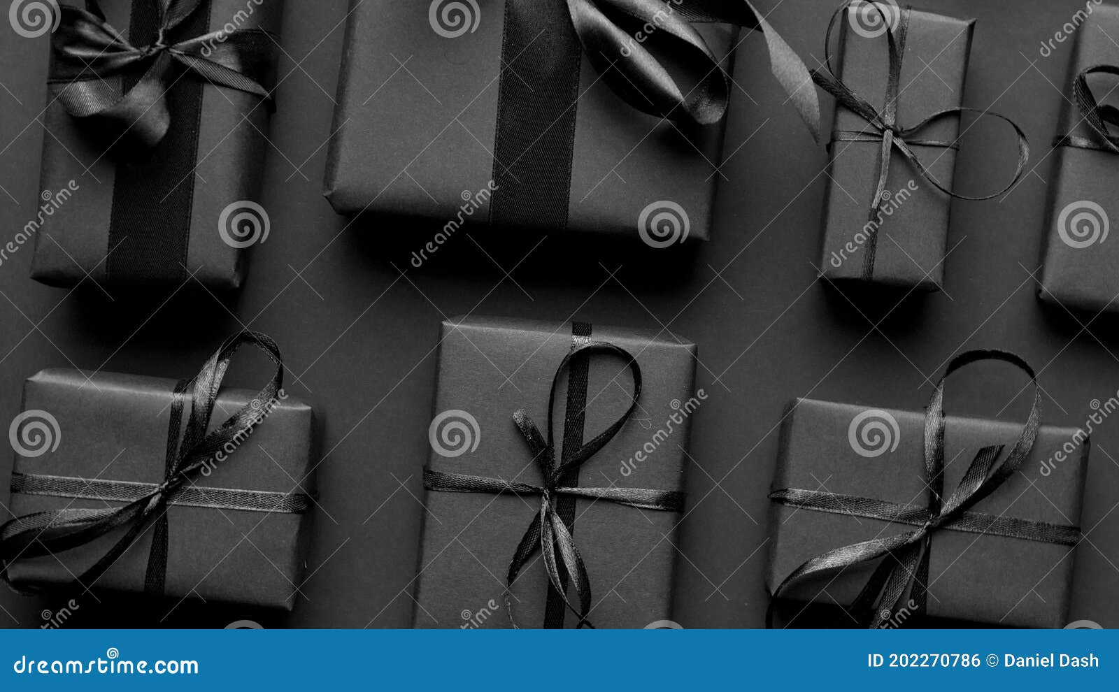 Elegant black Christmas theme. Wrapped gifts in black matte paper