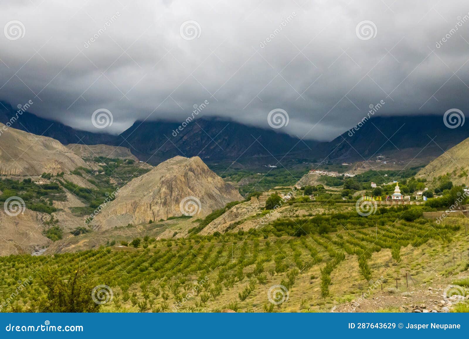 Dark Dramatic Desert Landscape with Foggy Mountains and Distant Houses ...