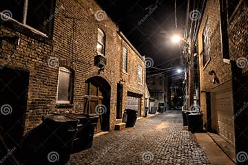Dark and Eerie Urban City Cobblestone Brick Alley at Night Stock Photo ...