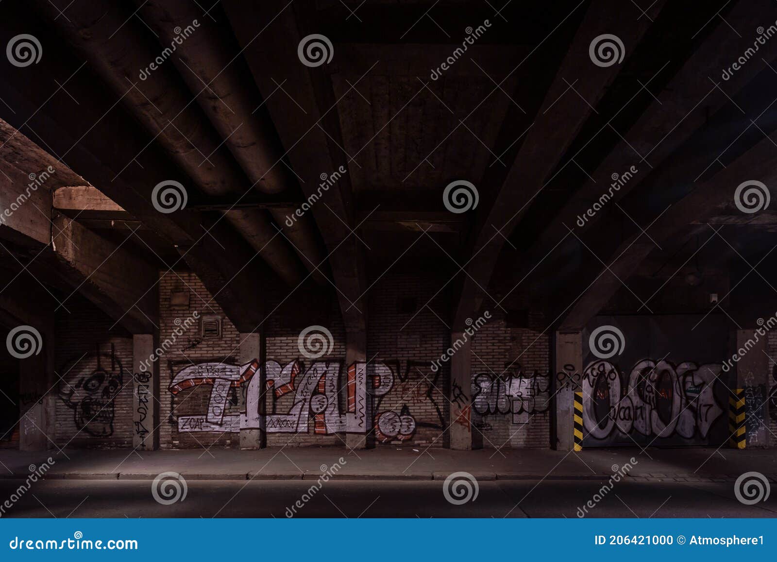 dark empty dirty grunge underground concrete tunel with a road during mystic night with blue street