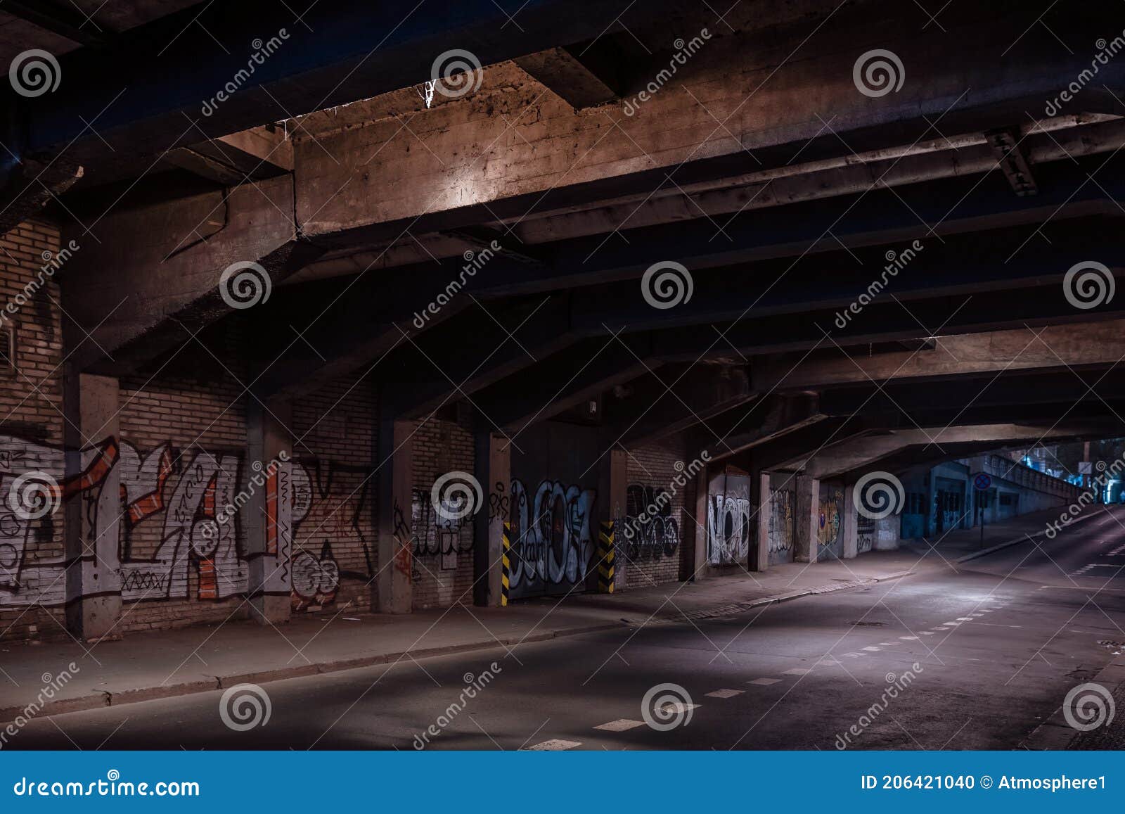 dark empty dirty grunge underground concrete tunel with a road during mystic night with blue street