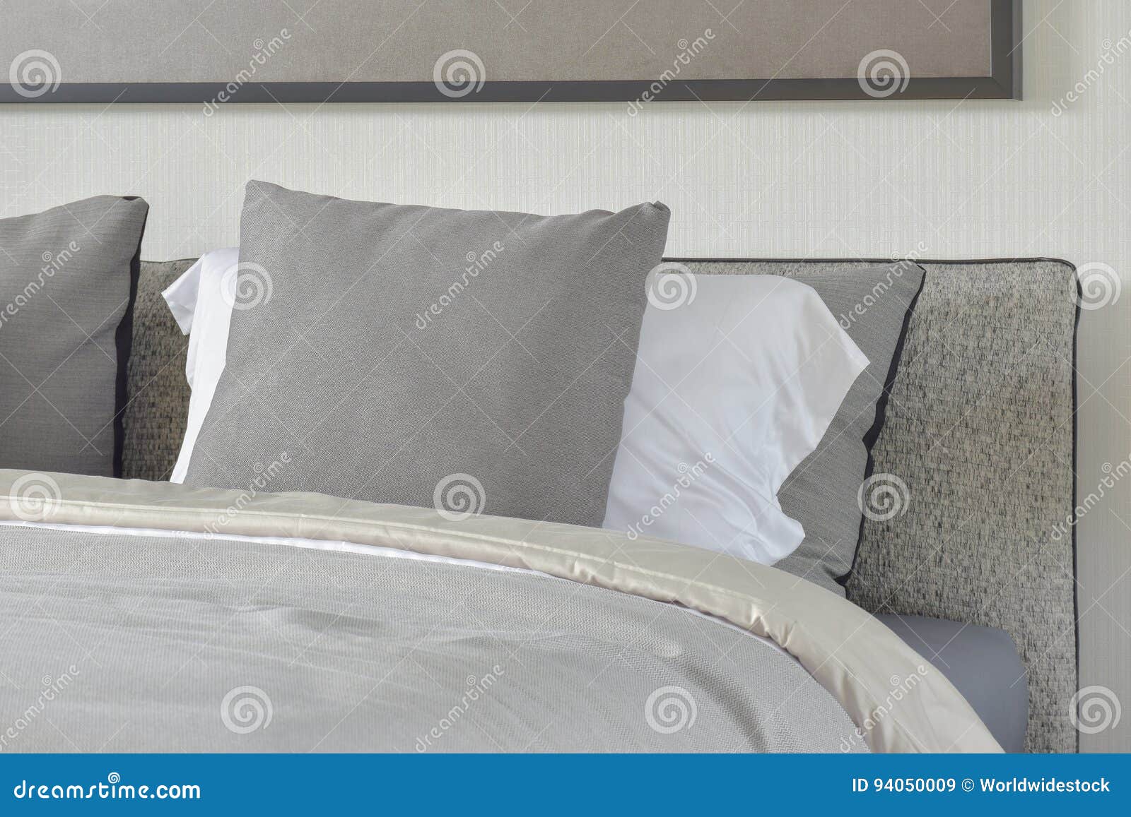 Dark Gray and White Pillows Setting on Bed with Blanket Stock Image