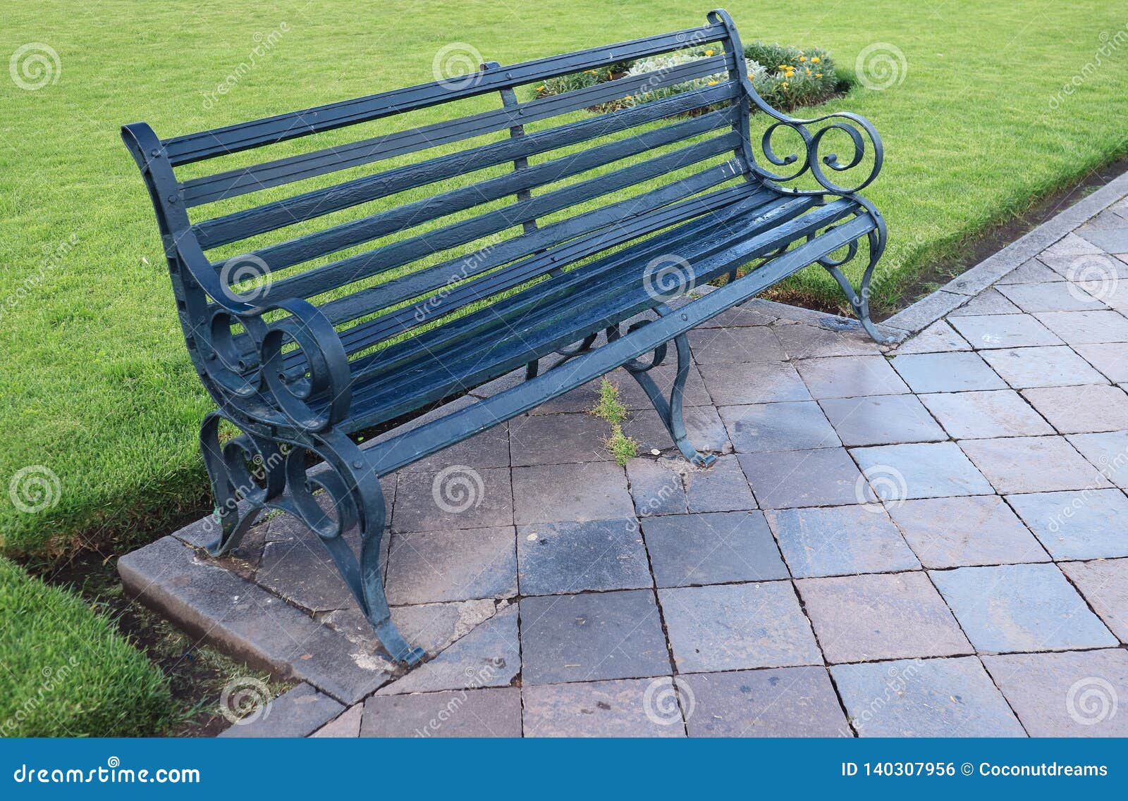 Dark Green Colored Wood And Wrought Iron Bench On The Main Square