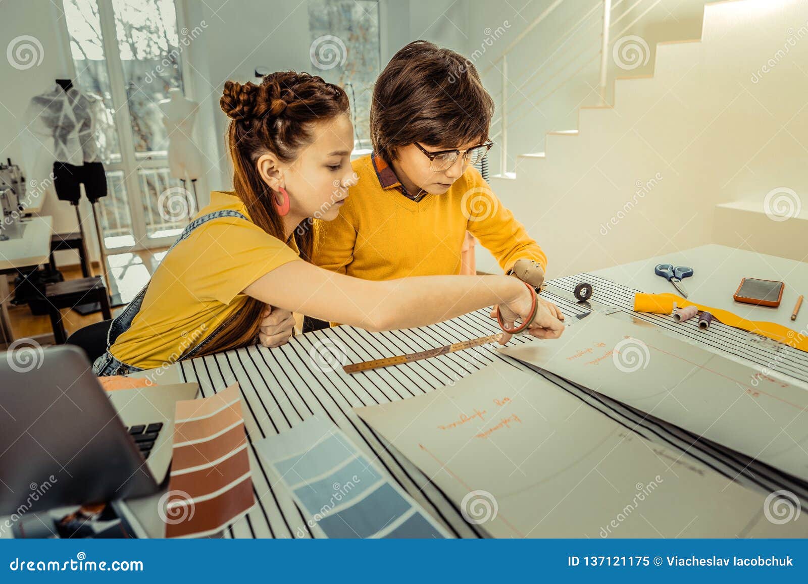 Dark-haired Brother and Sister Feeling Involved in Sewing Clothes Stock ...