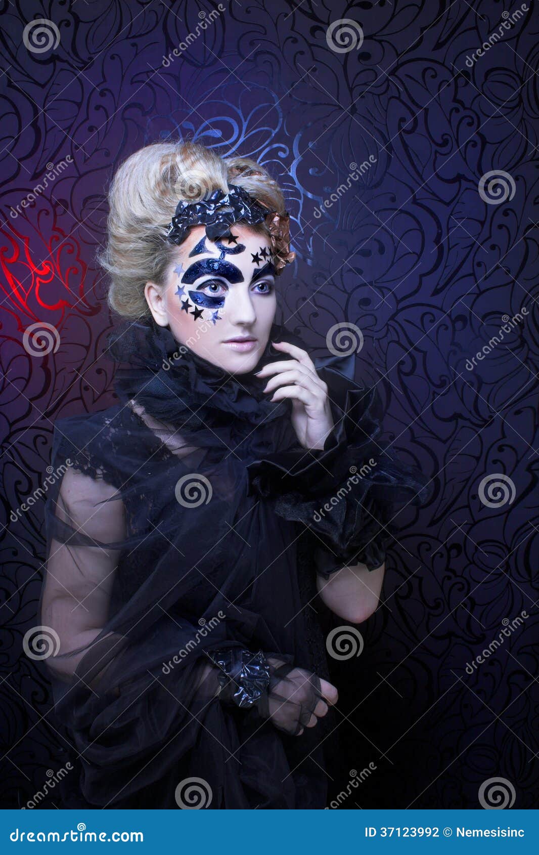 Dark Lady. Portrait of young woman in black with artistic makeup and hairstyle.