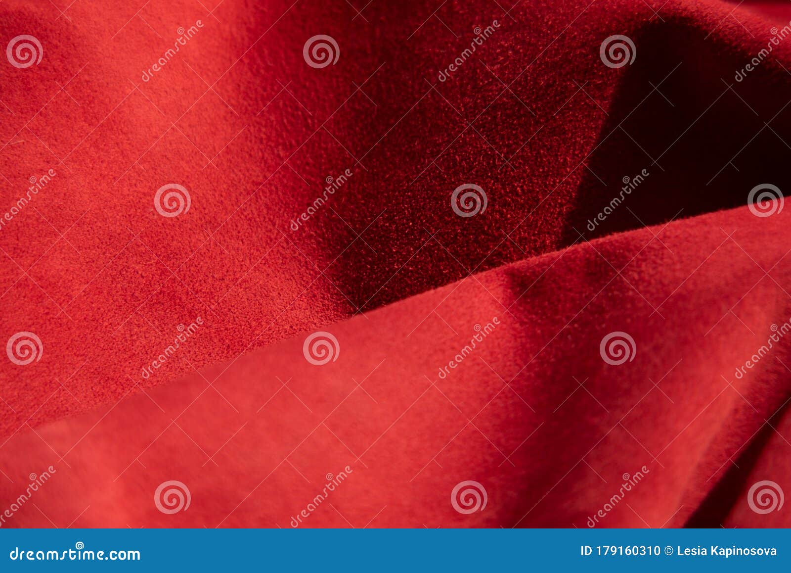 dark red matte background of suede fabric, closeup. velvet texture of seamless wine leather. felt material macro.