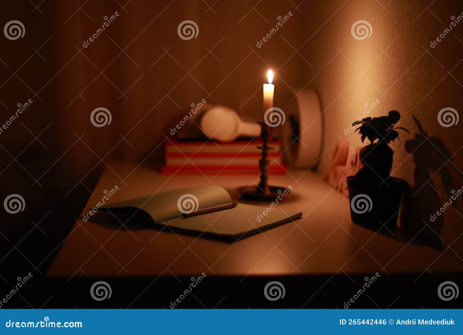 In the Dark Room, Burning Candle in Candlestick is Lighting on the Work