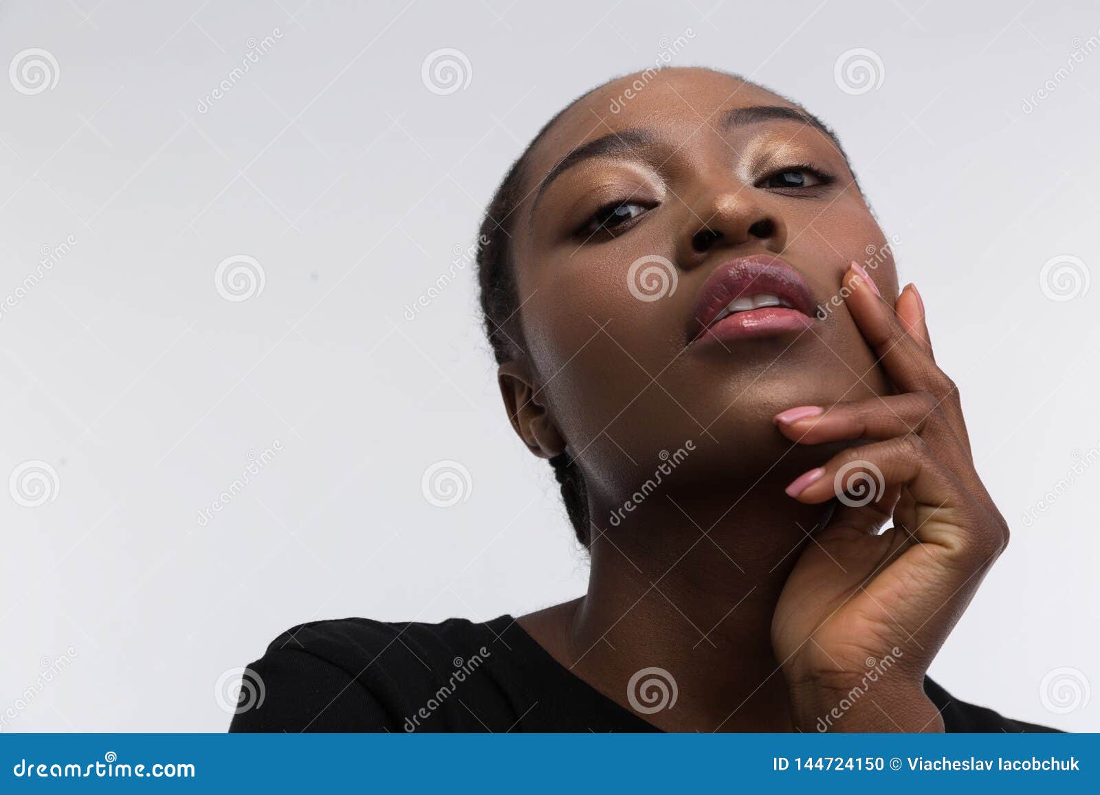 Darkskinned Professional Model Posing Near Light Background Stock