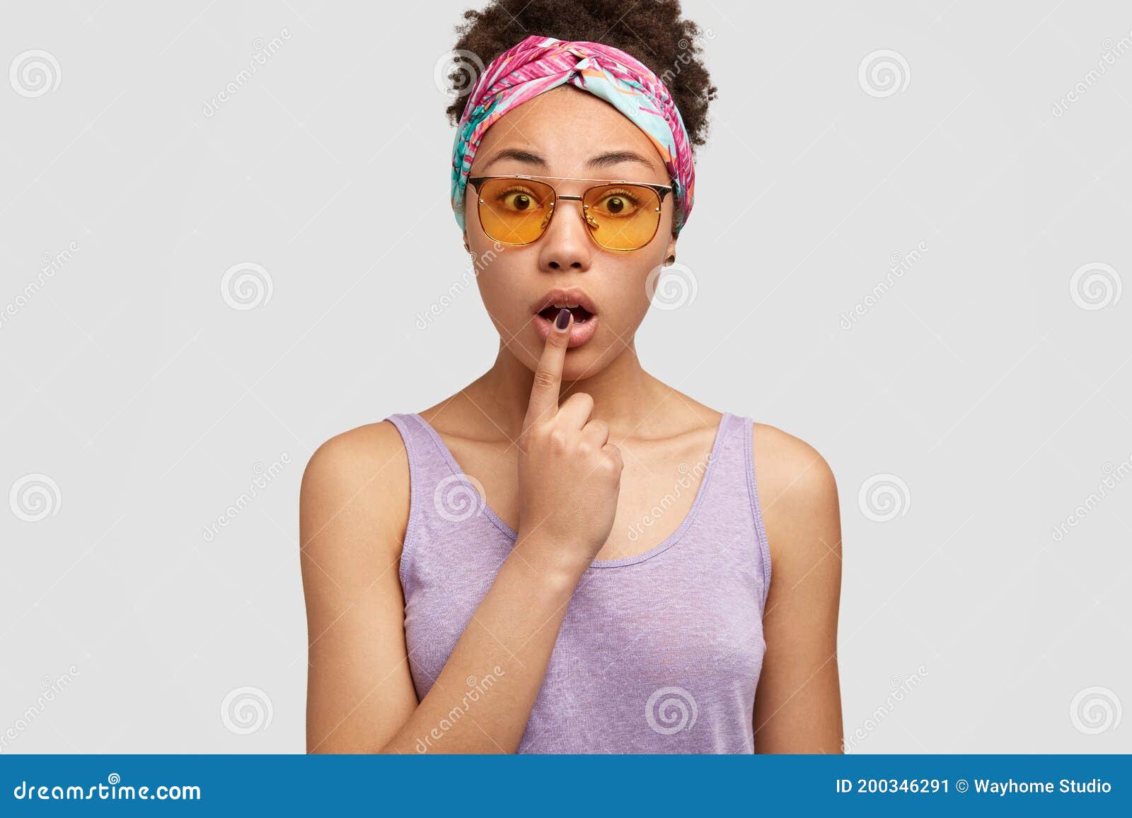 Dark Skinned Woman Opens Mouth Keeps Fore Finger At Lip Has