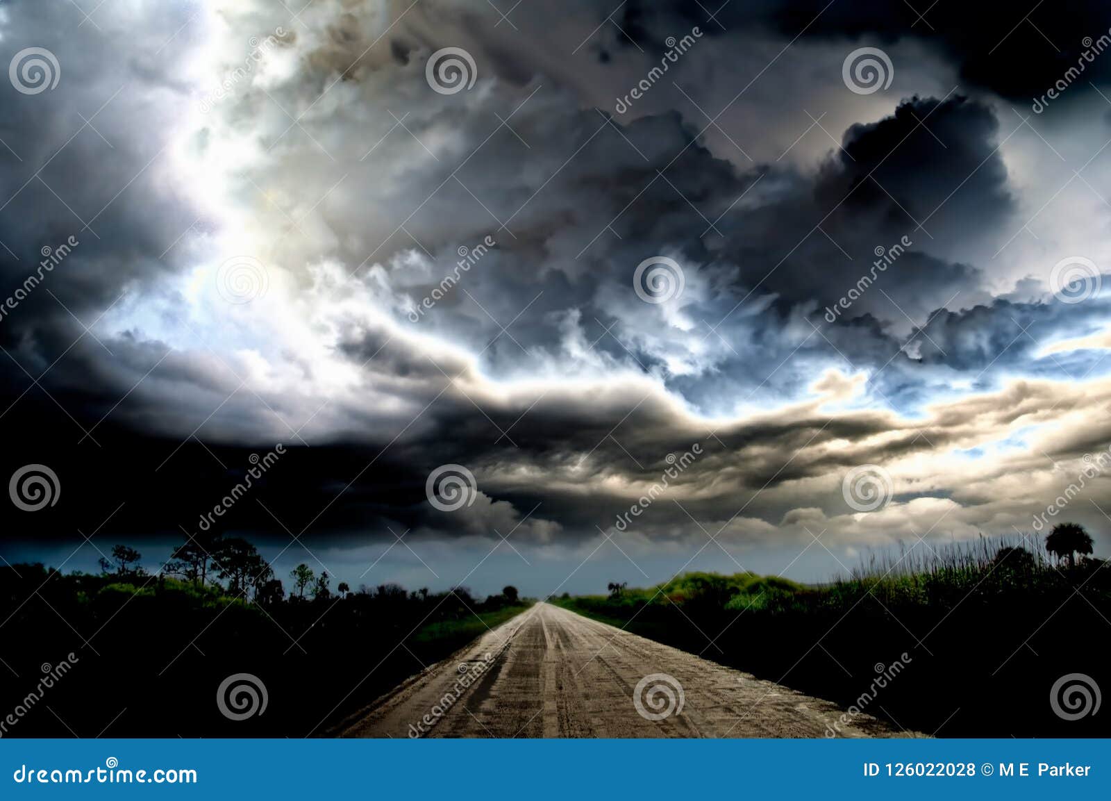 dark thunder clouds and dramatic storms over a rural road.