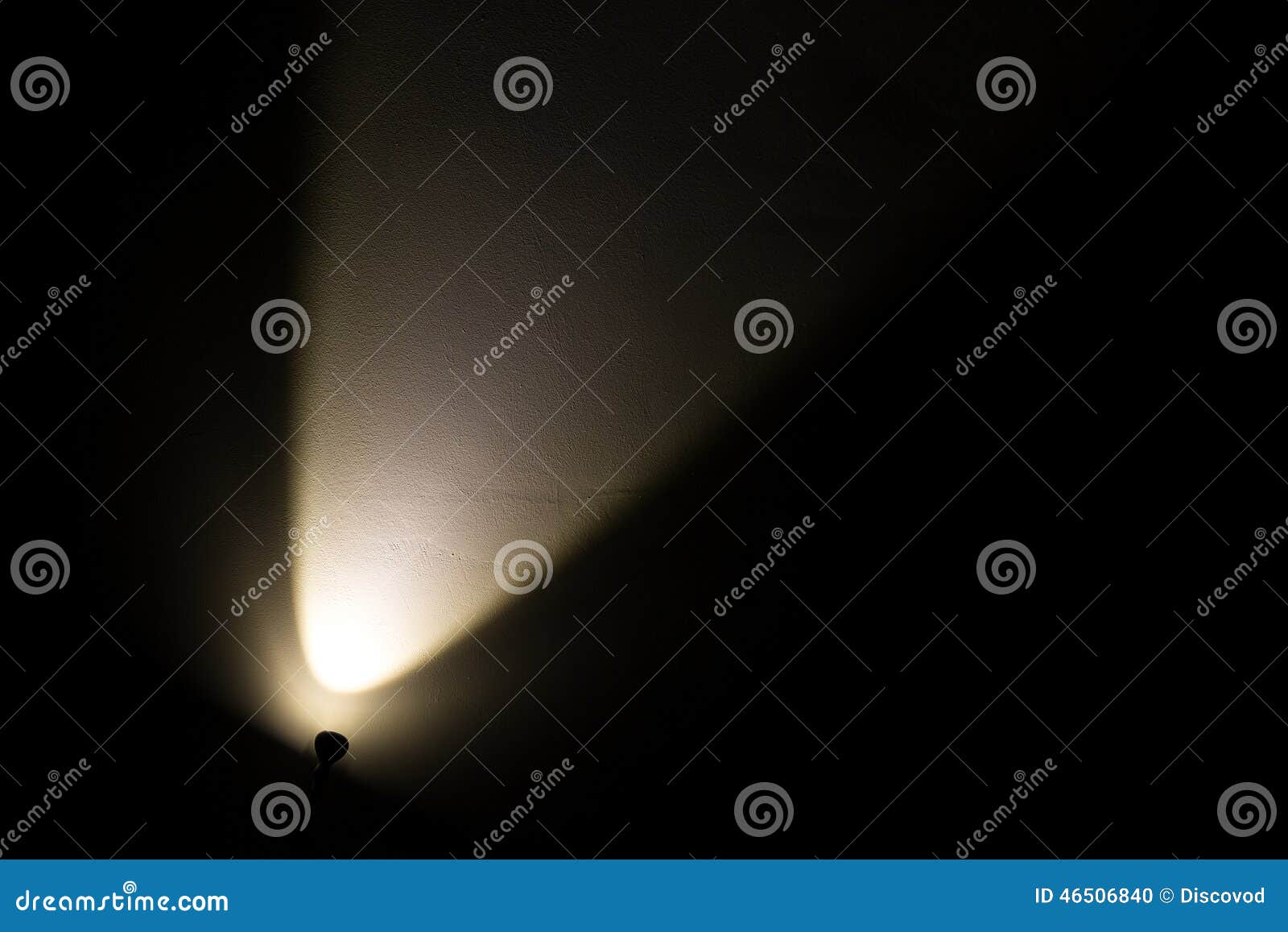 Dark Wall Illuminated from the Left Corner Spotlight Lamp Stock Photo