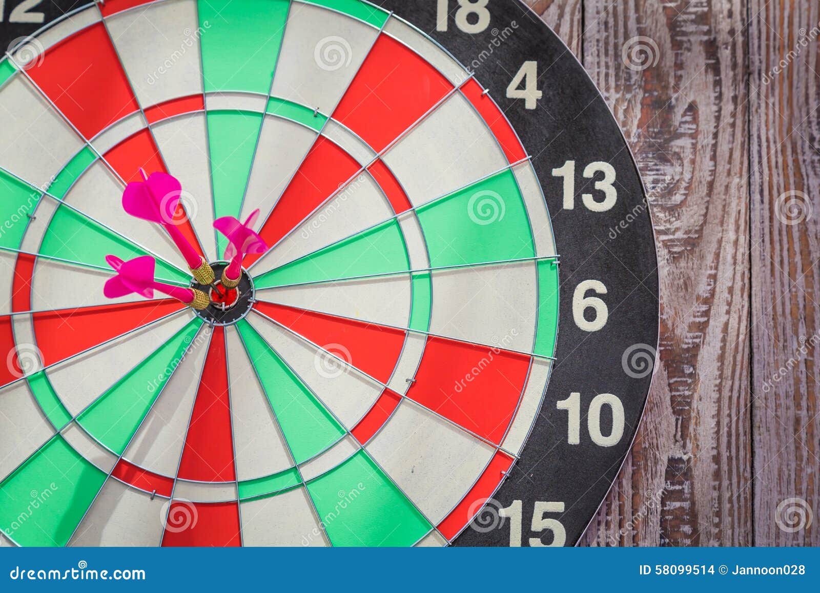 Dartboard on wood wall stock photo. Image of metallic 58099514