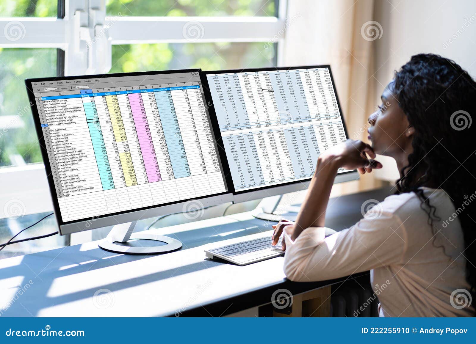 data analyst african woman using spreadsheet