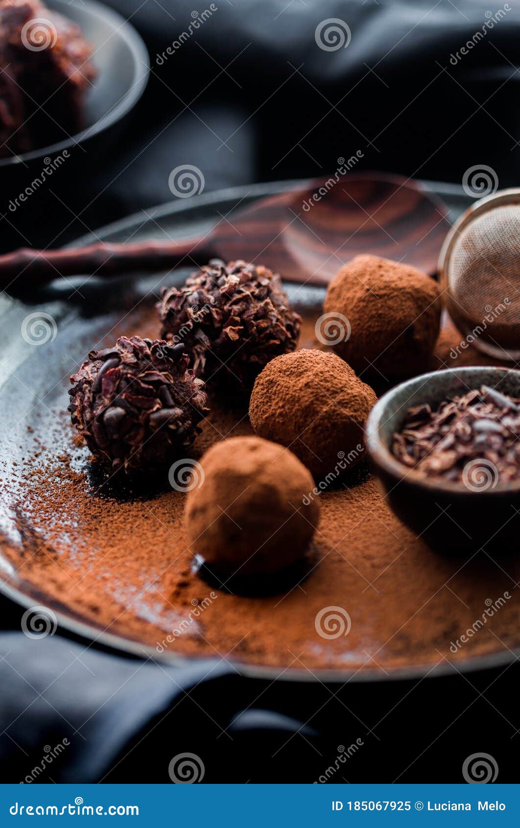 Date Energy Ball with Cocoa on a Black Dish and Cocoa Nibs Stock Image