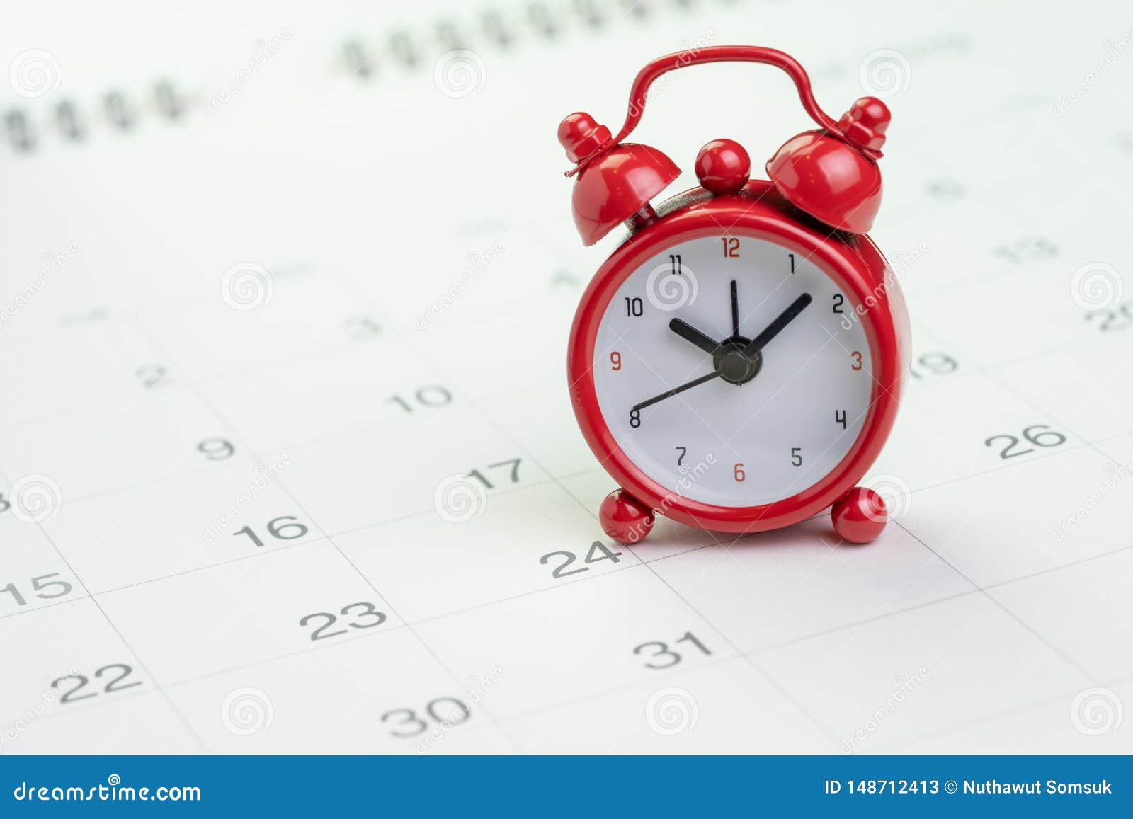 date and time reminder or deadline concept, small red alarm clock on white clean calendar with number of day, counting down to