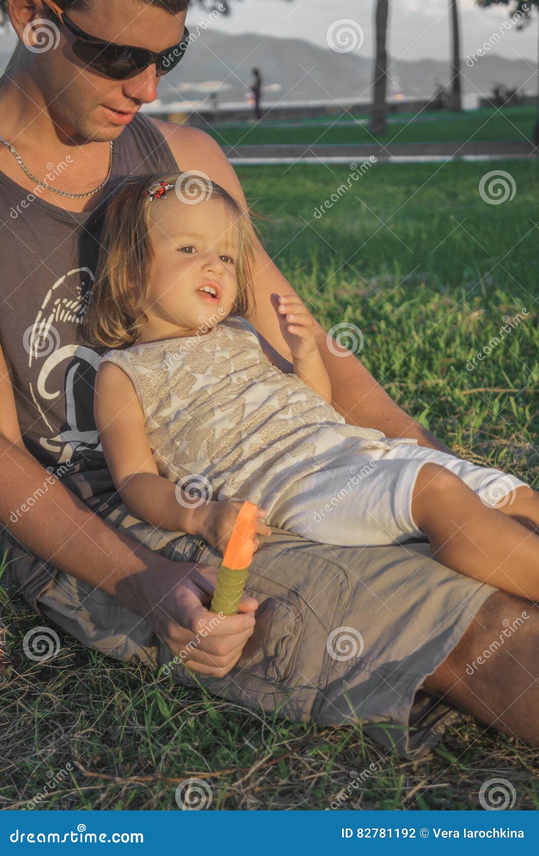 Daughter Sitting on the Lap of Dads Stock Ph photo image