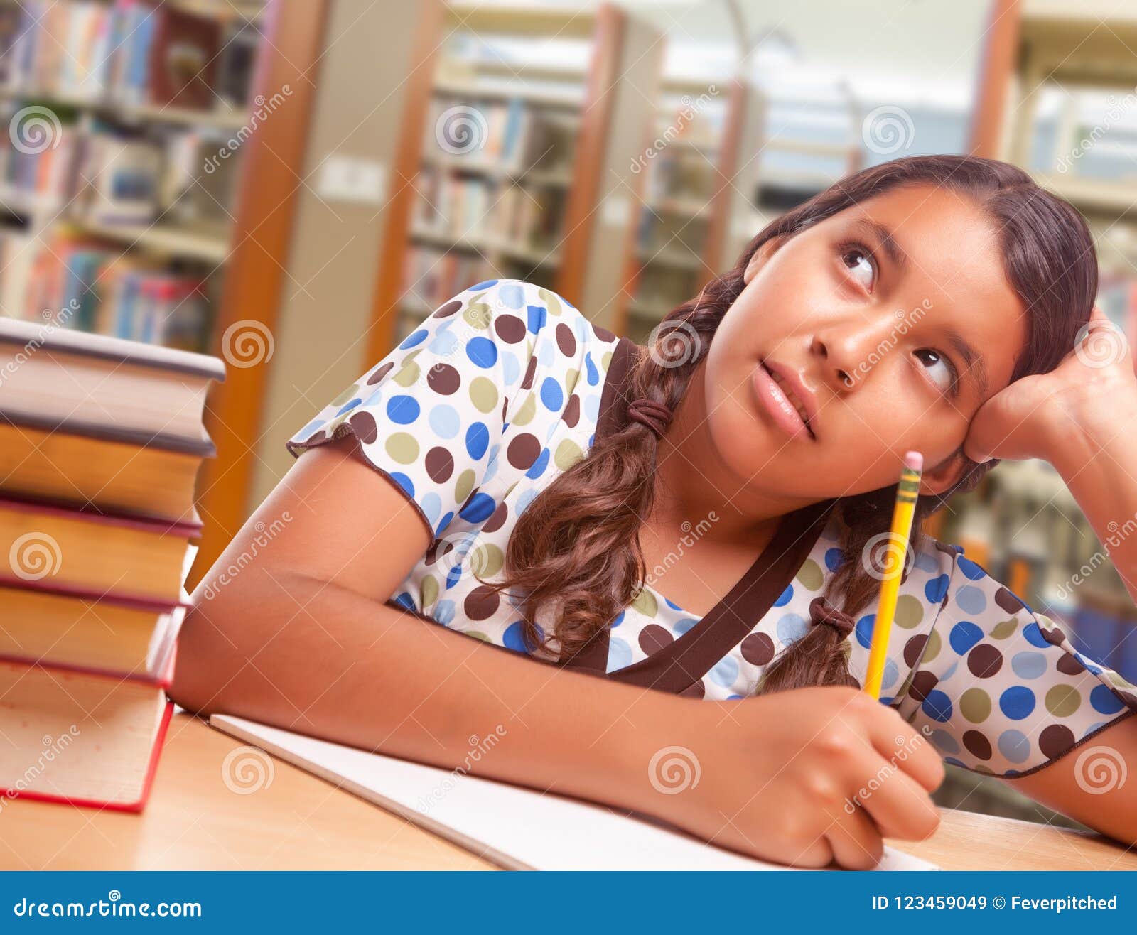 daydreaming hispanic girl student with pencil and books studying