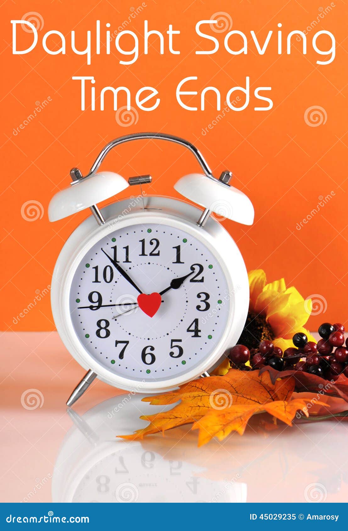 daylight savings time ends in autumn fall with clock concept and text message