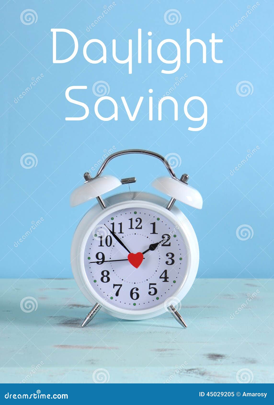 daylight savings time white clock on a vintage aqua blue wood table