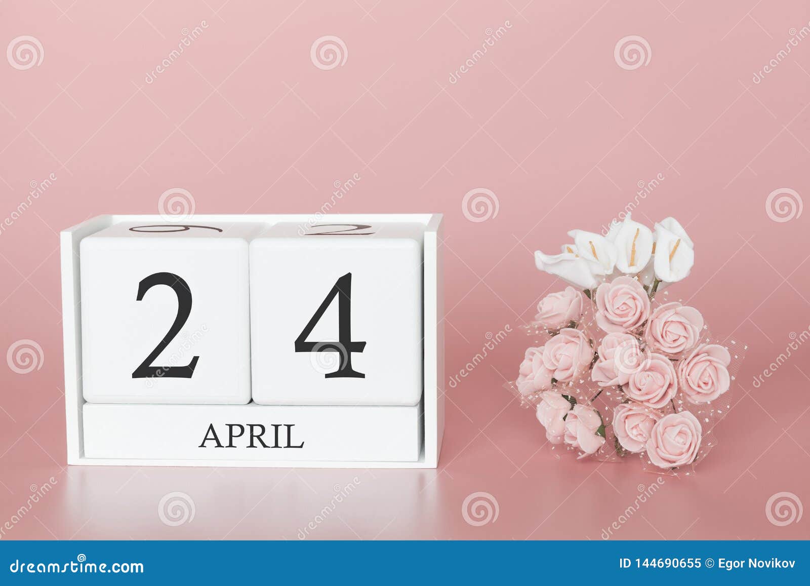 April 24th. Day 24 of month. Calendar cube on modern pink background, concept of bussines and an importent event