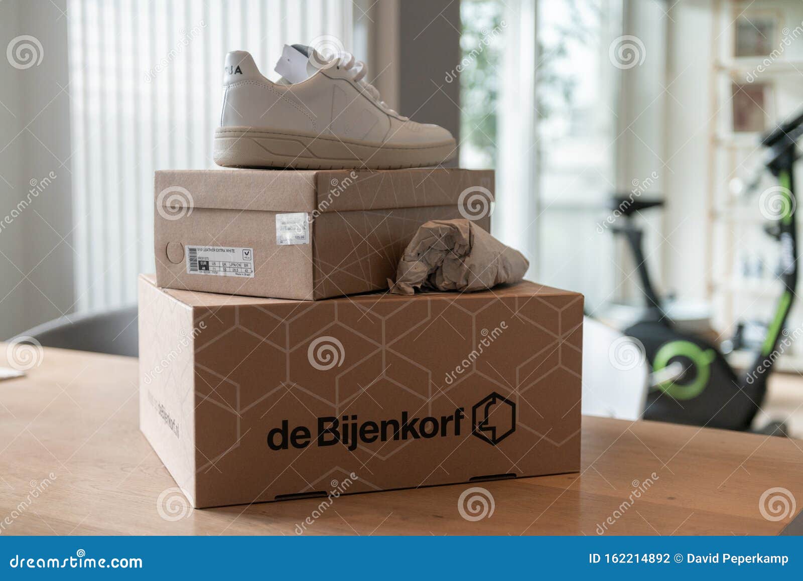 De Bijenkorf Online Package Delivery, Unboxing Package, Online Shopping, Fashion Shoes, White Sneakers, Box on the Table Editorial Photography - of fashion, delivery: