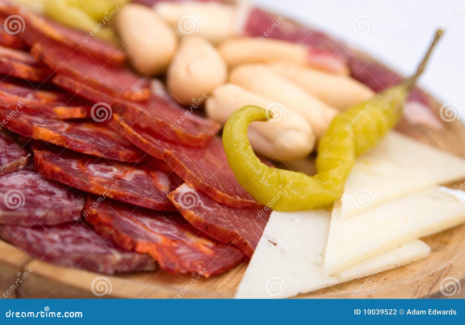 De schotel van het voorgerecht van koud vlees met groene Spaanse peper. Een schotel van koud vlees, kaasplakken, groene Spaanse peper, en mini-baguettes die als voorgerecht wordt gediend