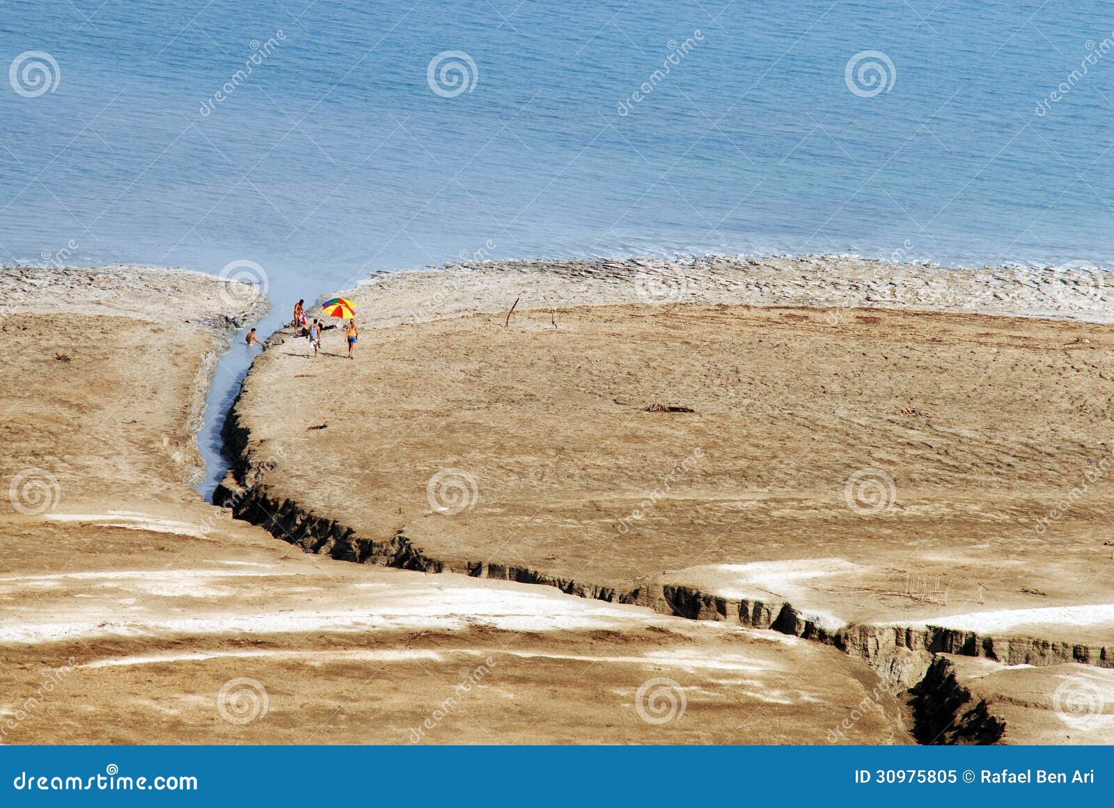 The Dead Sea - Israel. DEAD SEA, ISR - SEP 27:Israeli people look for mineral mud on the Dead Sea coastline on September 27 2007.The shores of Dead Sea mark the lowest elevation on earth.