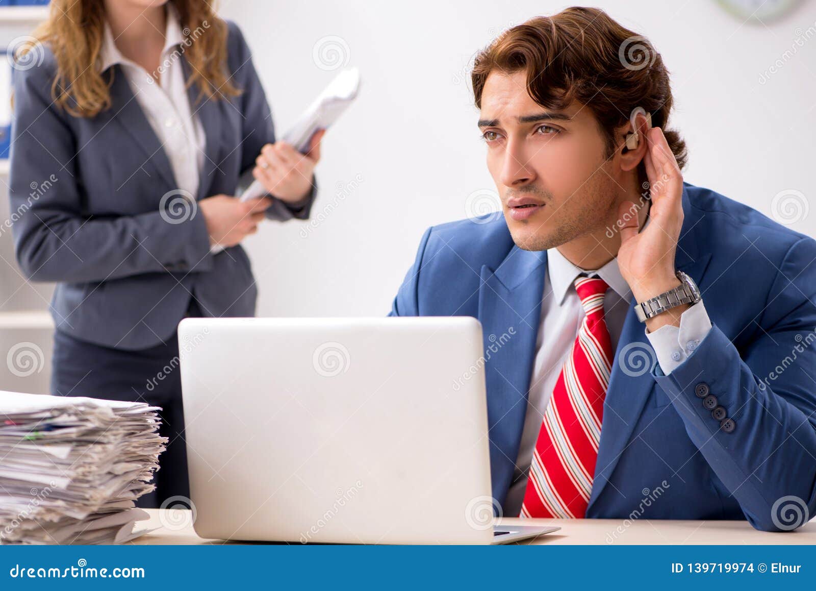 The Deaf Employee Using Hearing Aid Talking To Boss Stock Photo Image