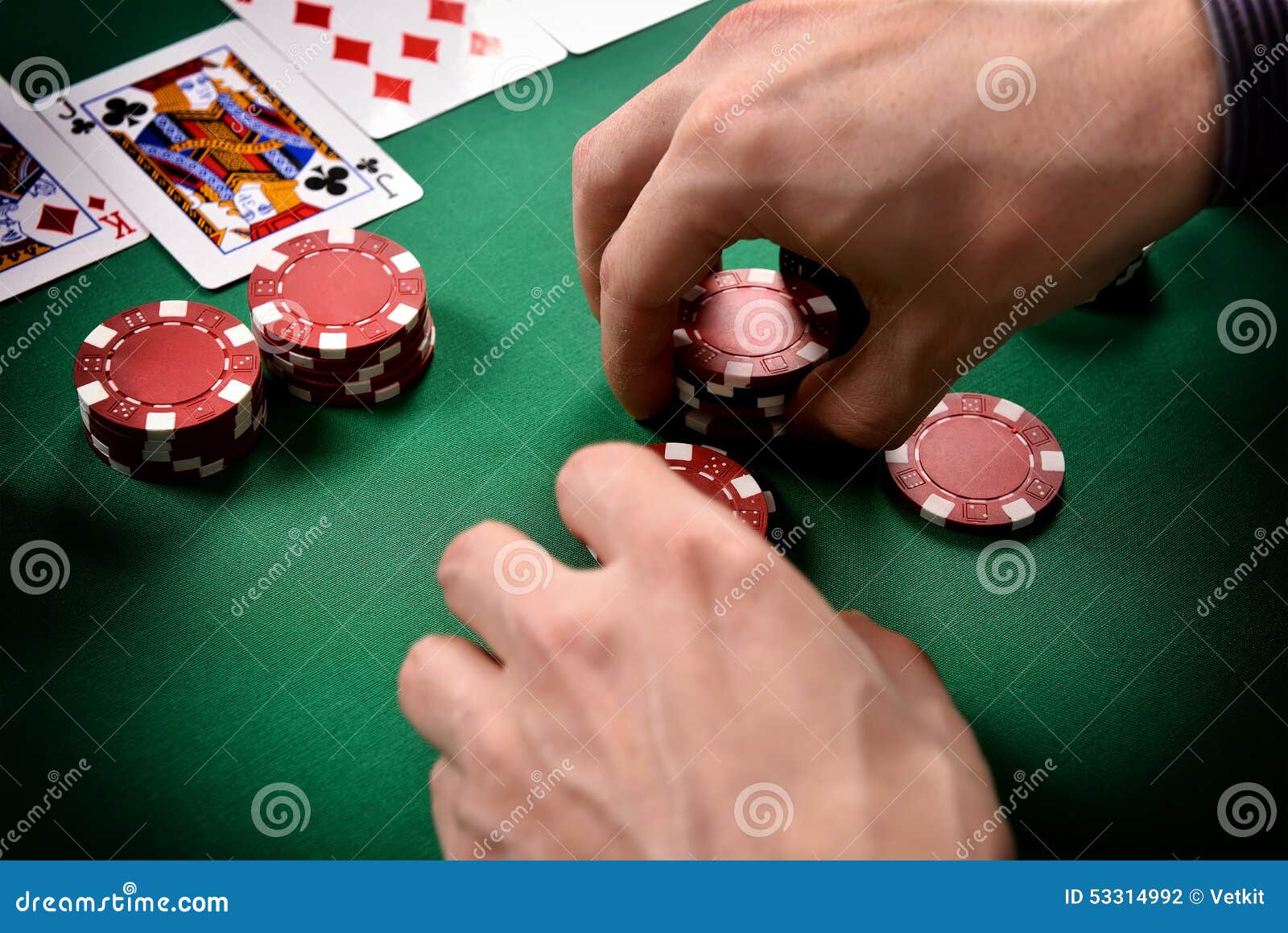 Dealer collects red poker chips from the table