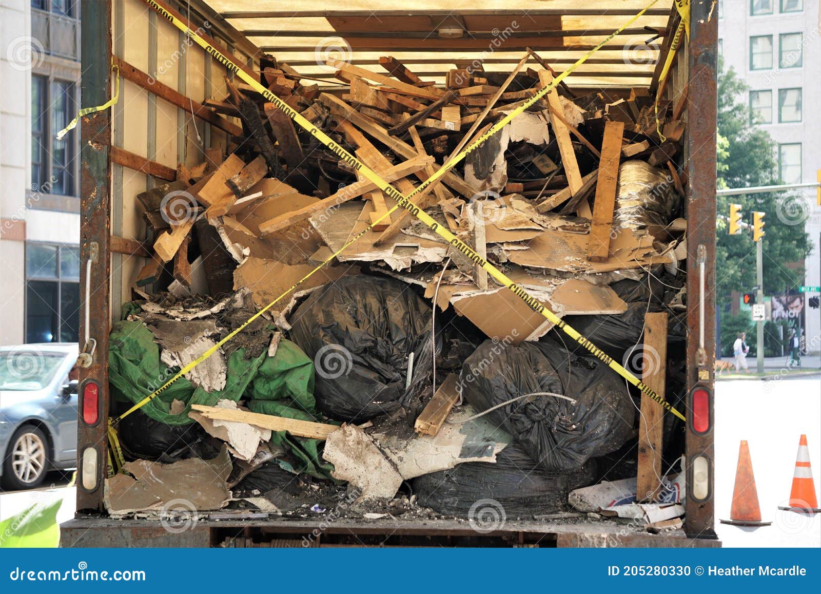 enclosed truck filled with broken charred trash and wood