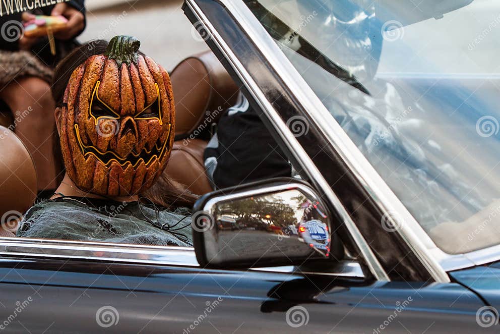 Girl Wears Creepy Pumpkin Mask in Decatur Halloween Parade Editorial