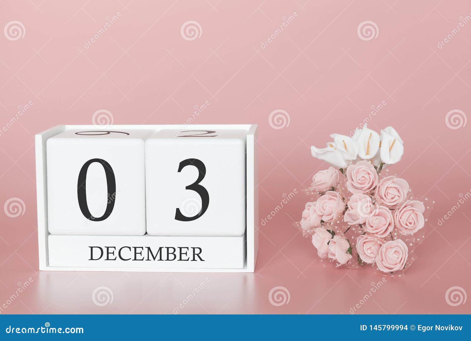 december 03rd. day 3 of month. calendar cube on modern pink background, concept of bussines and an importent event