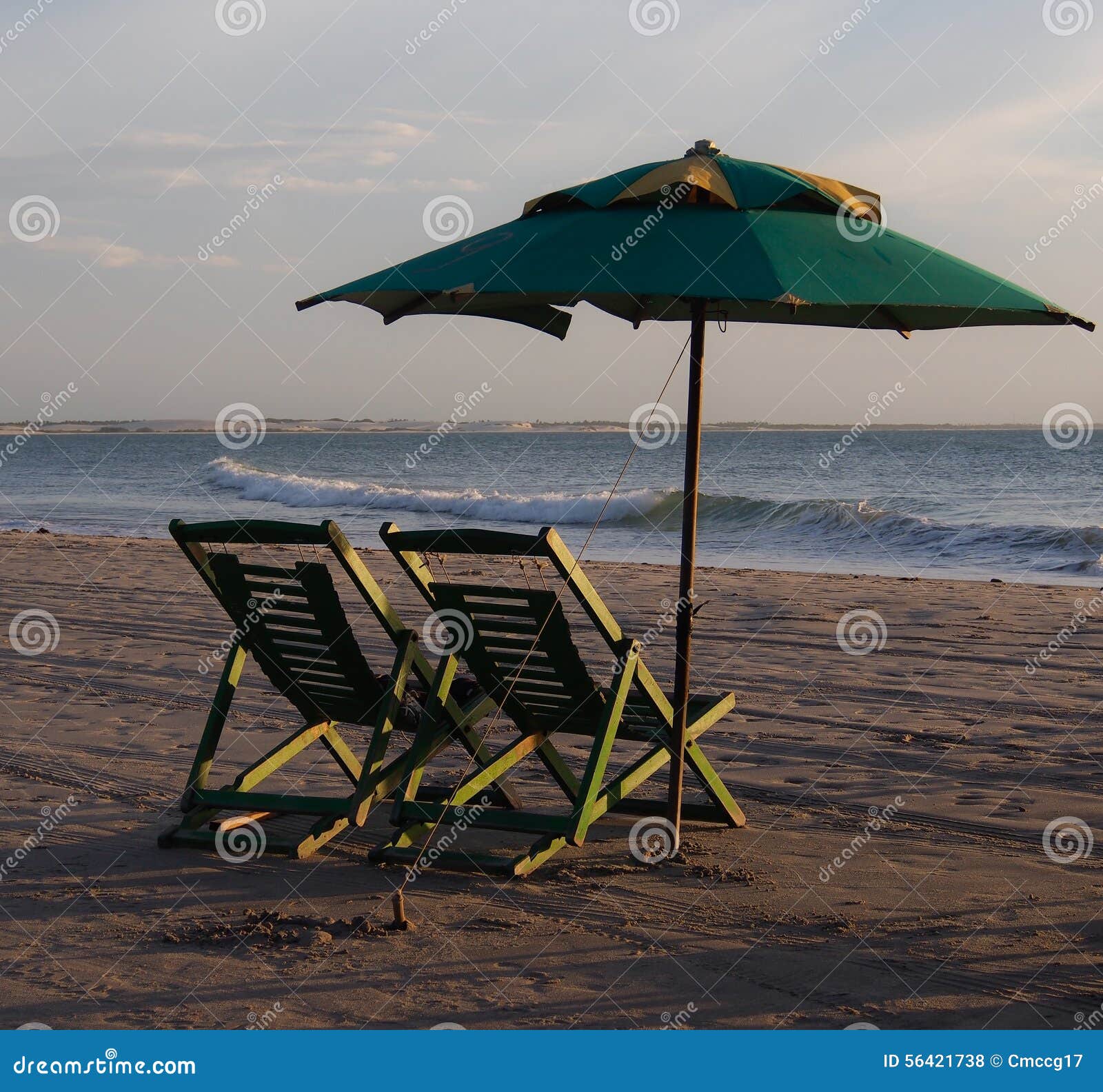 Two deckchair and parasol in the beach