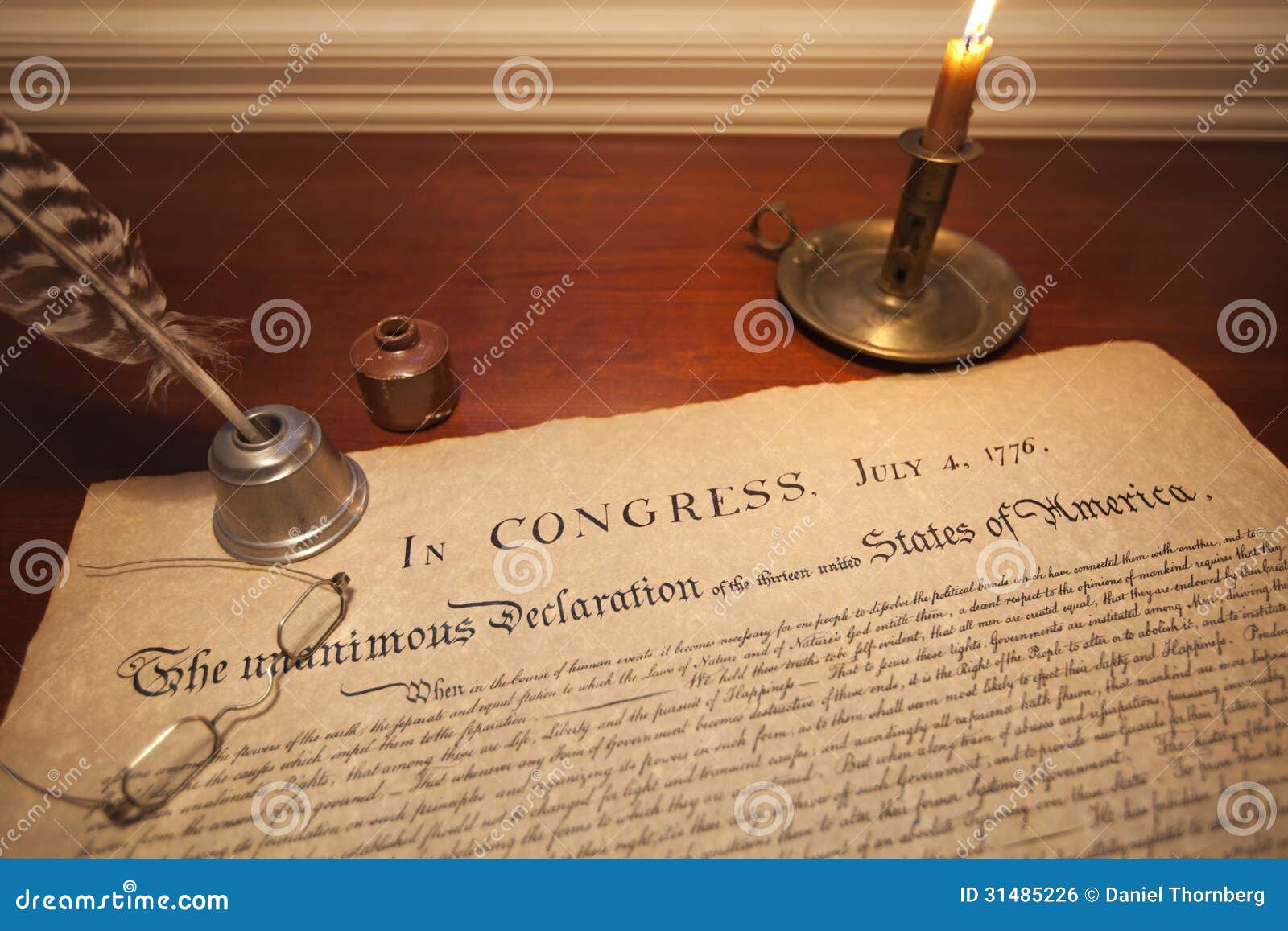 declaration of independence with glasses, quill pen and candle