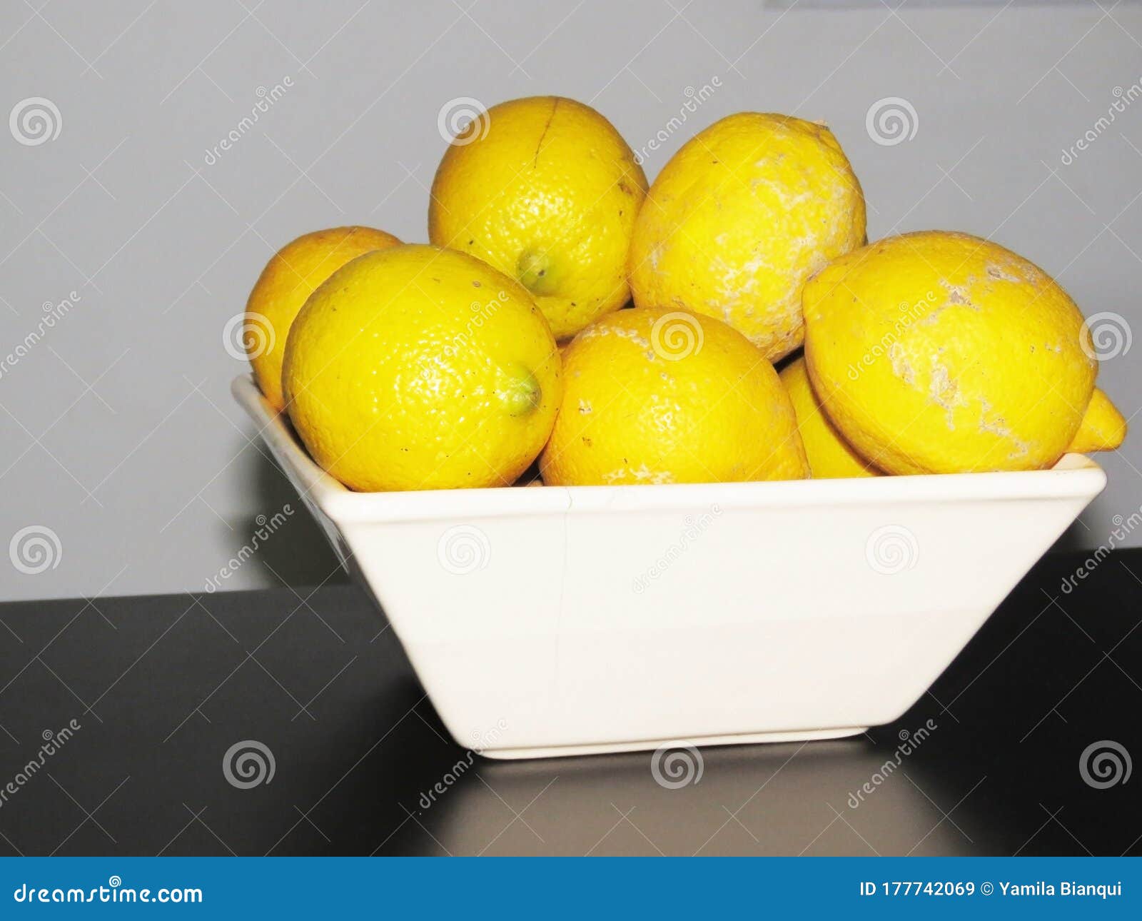 decomposing lemons stacked in a bowl