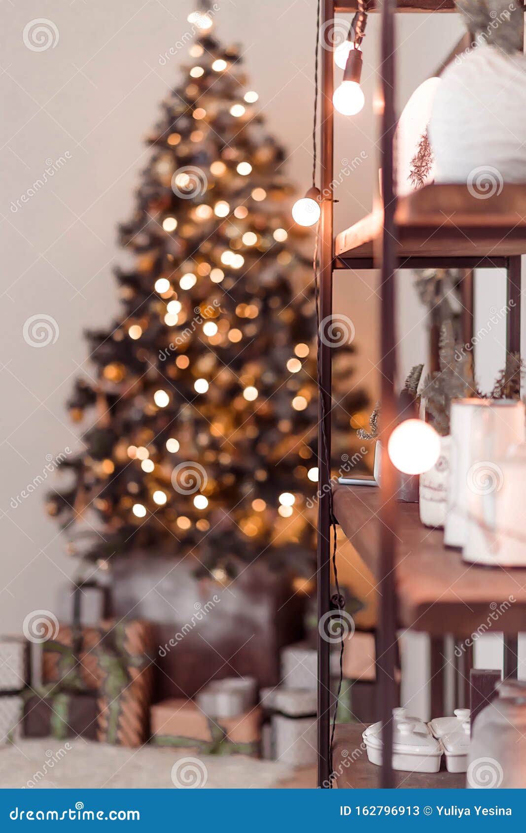 Decorated Bookshelf and Christmas Tree in the Background Stock Image