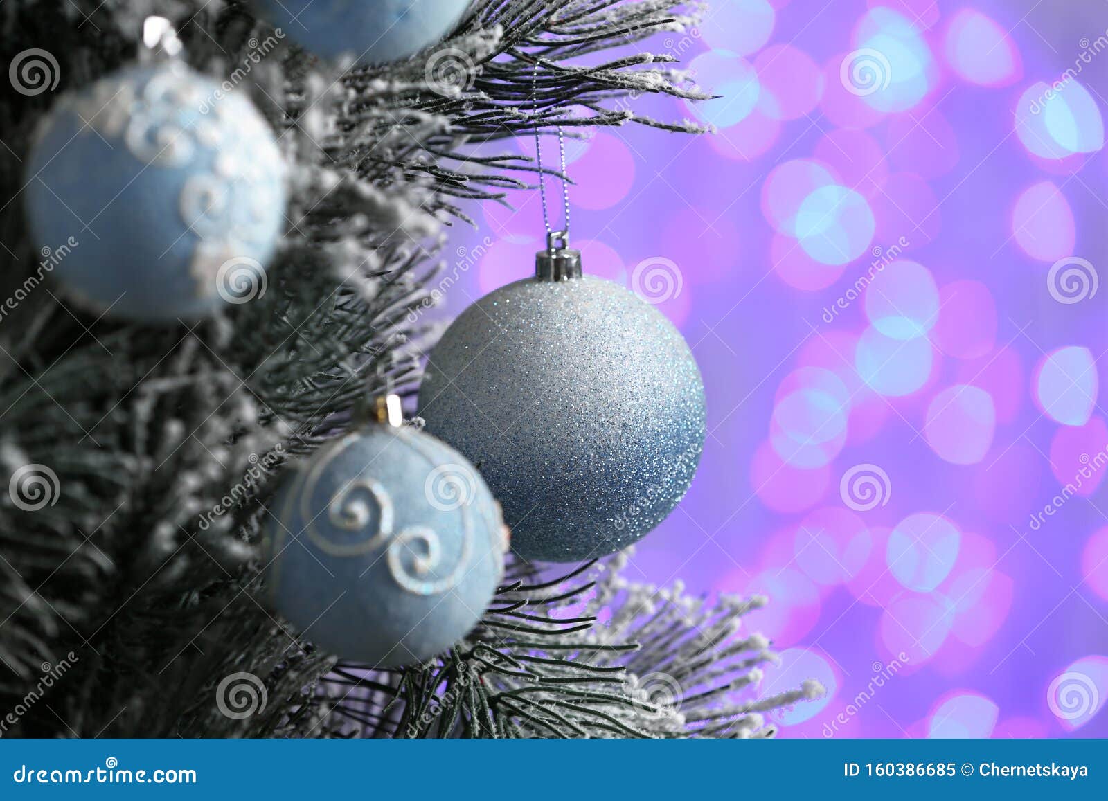 Decorated Christmas Tree Against Blurred Lights on Background Stock ...