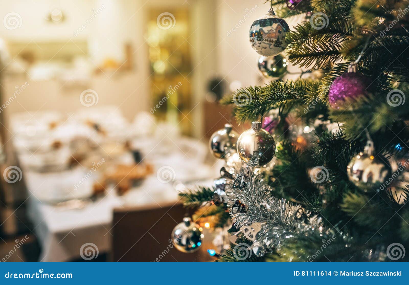 Decorated Christmas Tree with Dining Table in Background Stock Photo