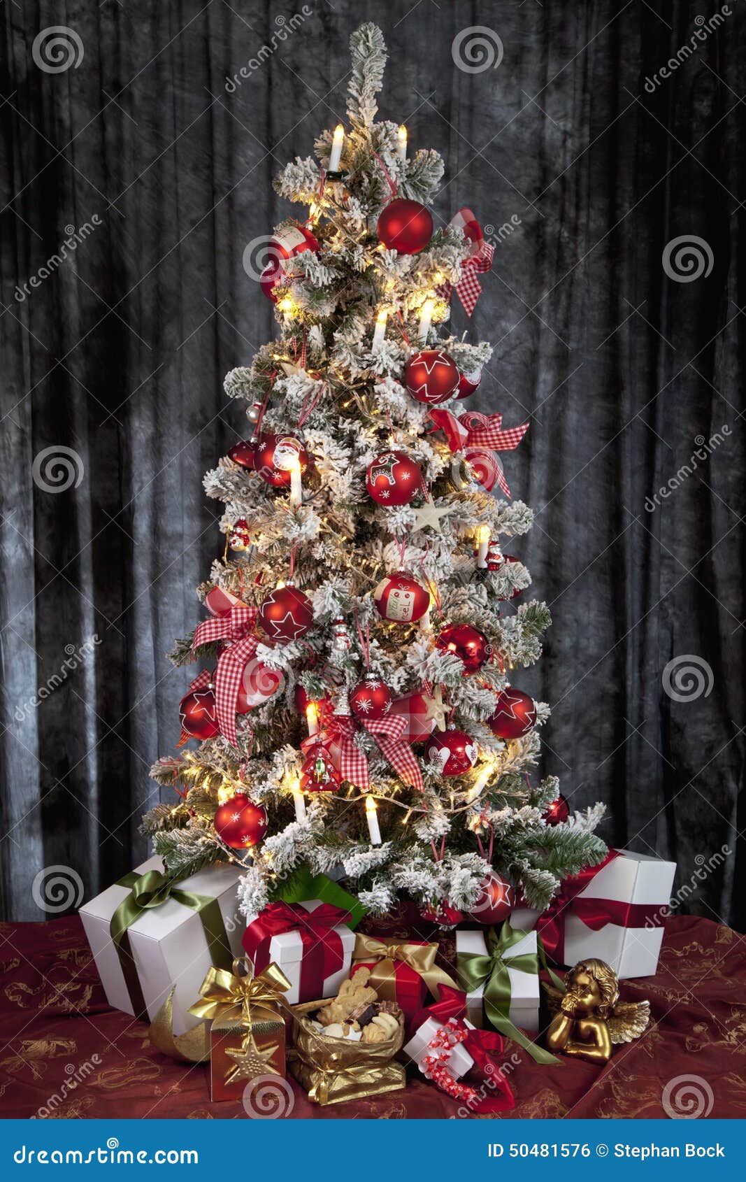 Decorated Christmas Tree with Electric Candles and Presents Stock Photo