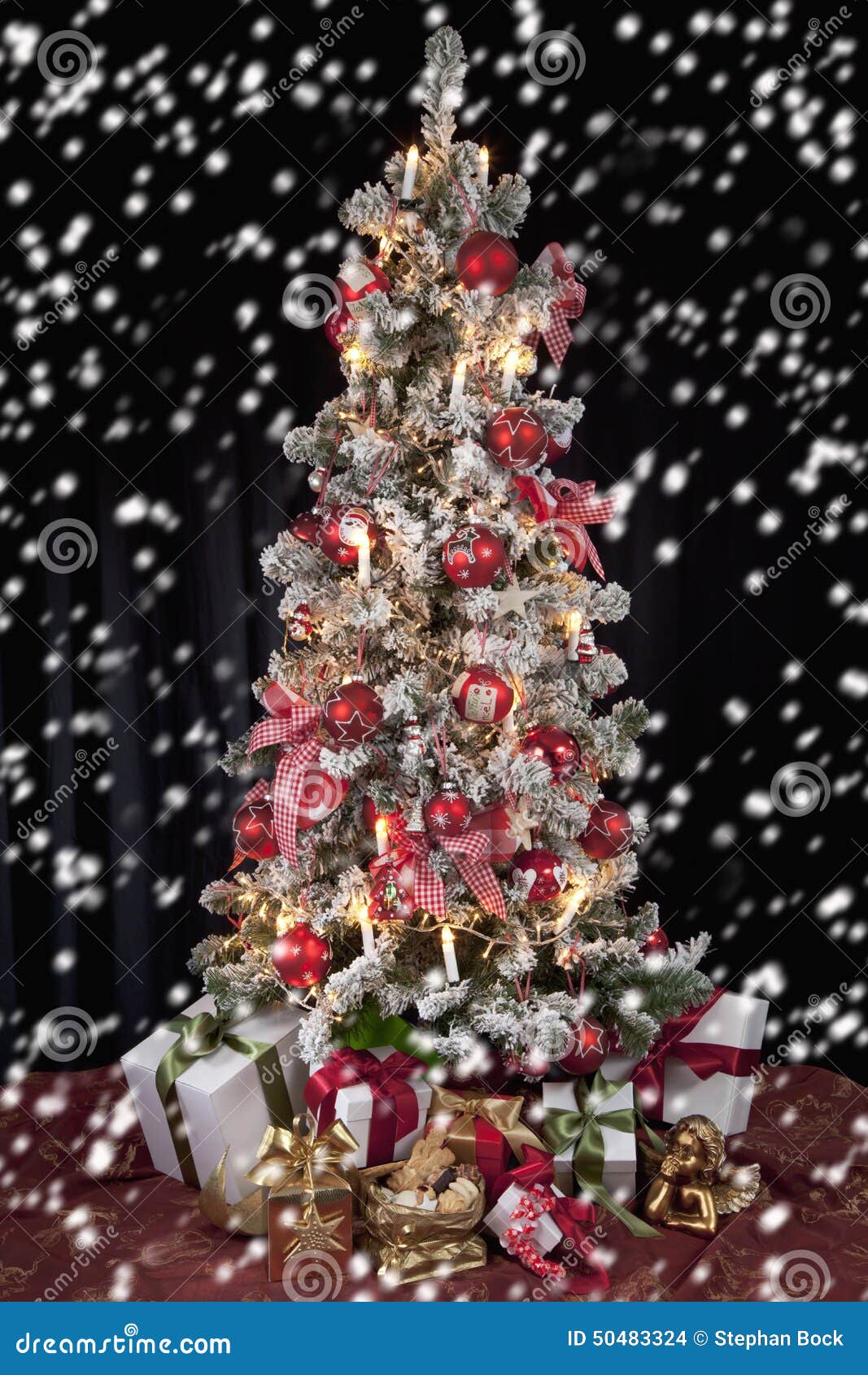 Decorated Christmas Tree with Electric Candles and Presents Stock Photo